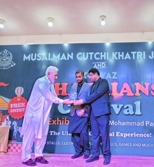 Receiving shield from General Secretary of Musalman Cutchi Khatri Jamat